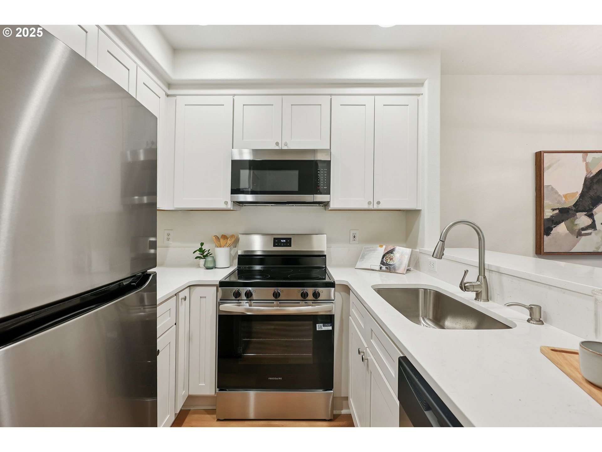 912 Southeast 193rd Avenue Portland, OR 97233 - Photo 12 of 28 a kitchen with stainless steel appliances granite countertop a sink a stove a microwave and cabinets