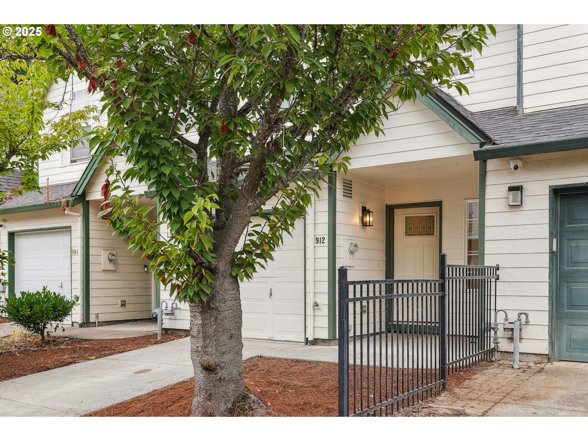 912 Southeast 193rd Avenue Portland, OR 97233 - Photo 2 of 28 a porch with a tree in front of it