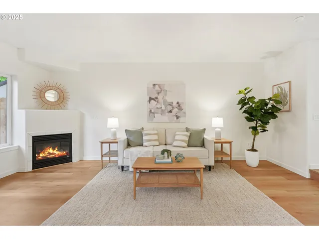 a living room with furniture and a dining table with wooden floor