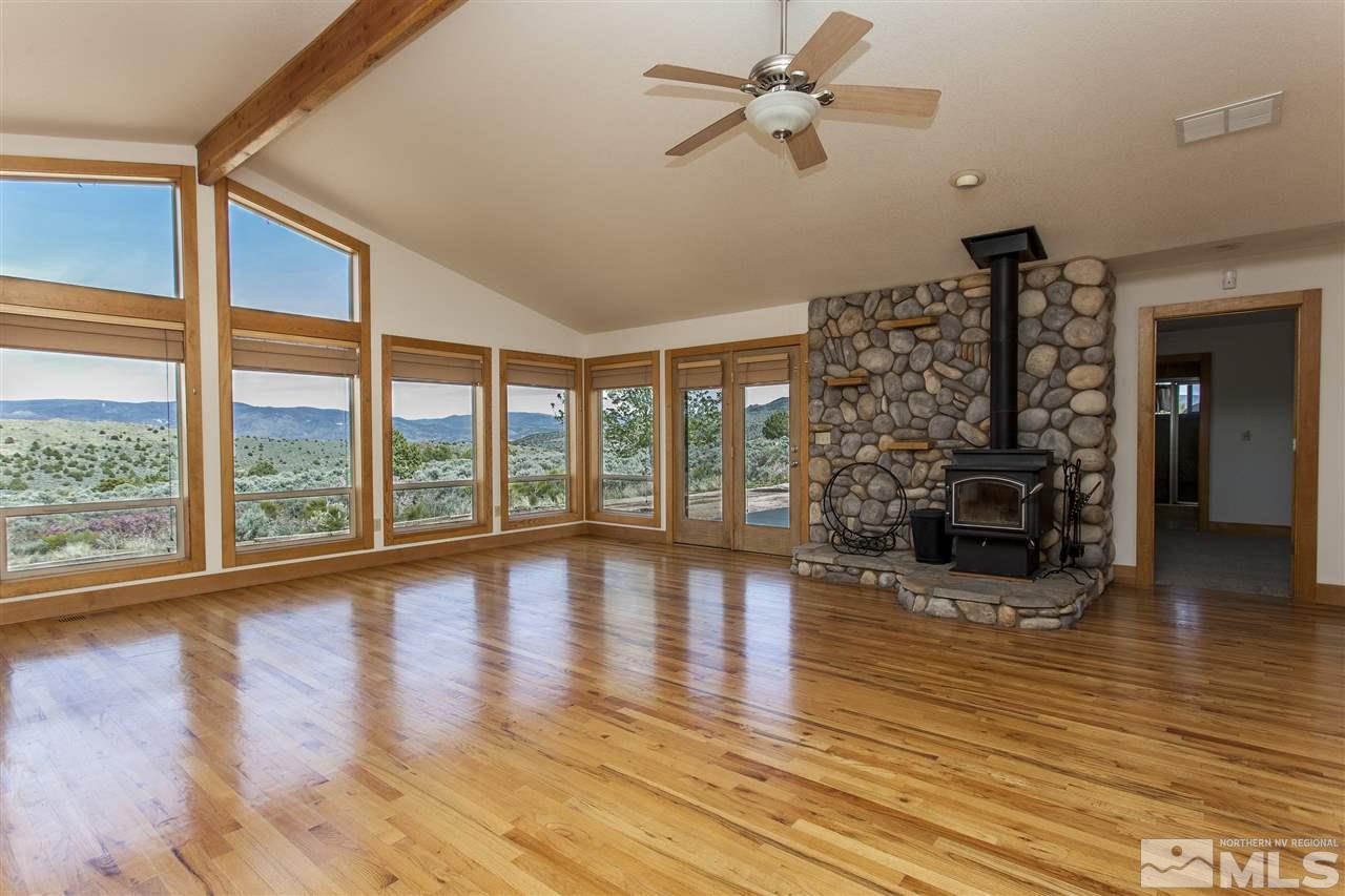 505 Space Test Road Reno, NV 89510 - Photo 12 of 25 a view of empty room with wooden floor and fireplace