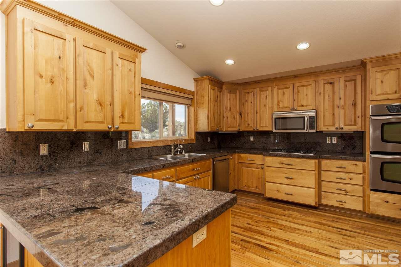 505 Space Test Road Reno, NV 89510 - Photo 13 of 25 a kitchen with stainless steel appliances granite countertop a stove a sink and a microwave