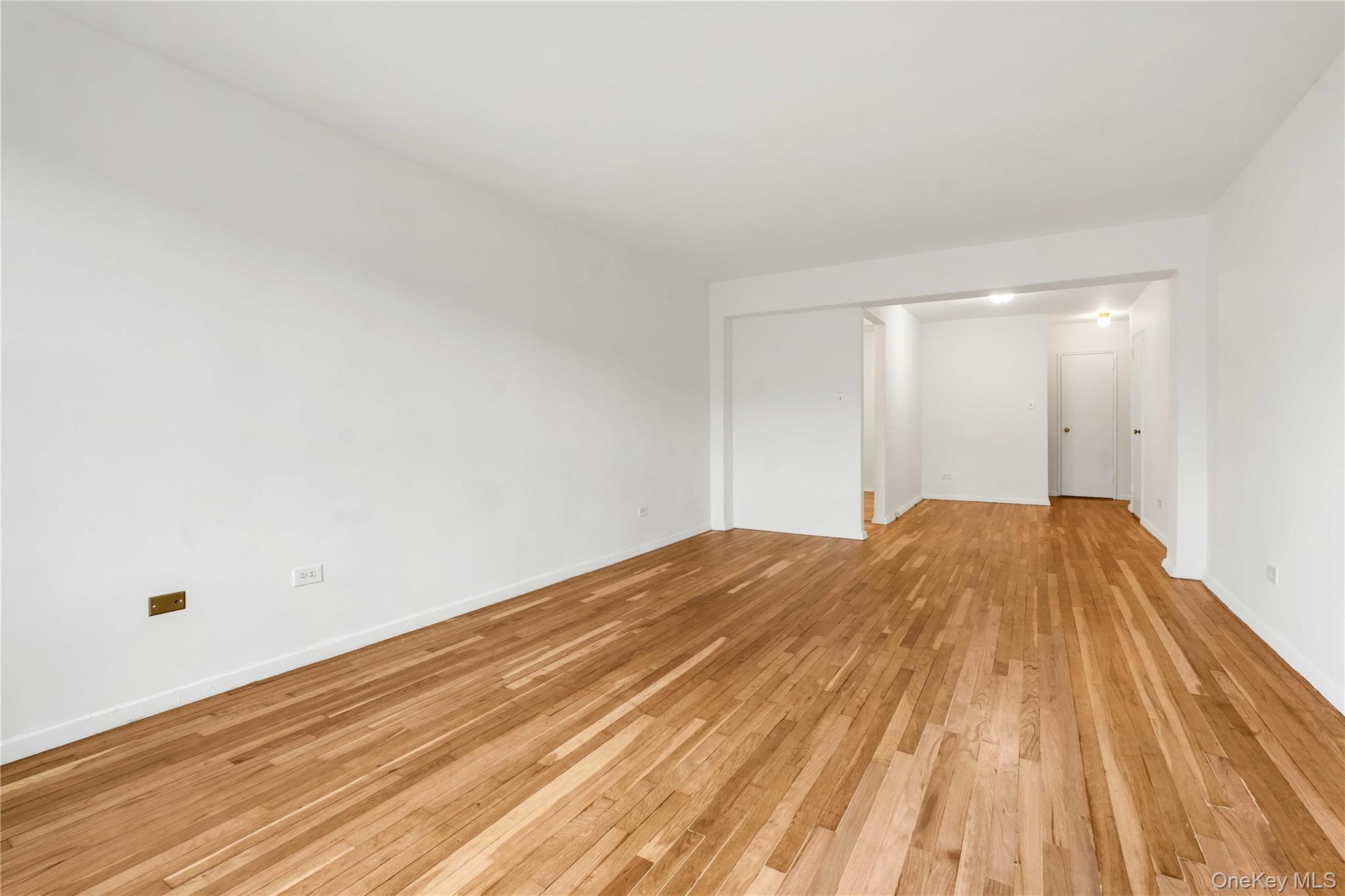110-15 71st Road, Unit 6J Queens, NY 11375 - Photo 11 of 23 a view of a room with wooden floor and white walls
