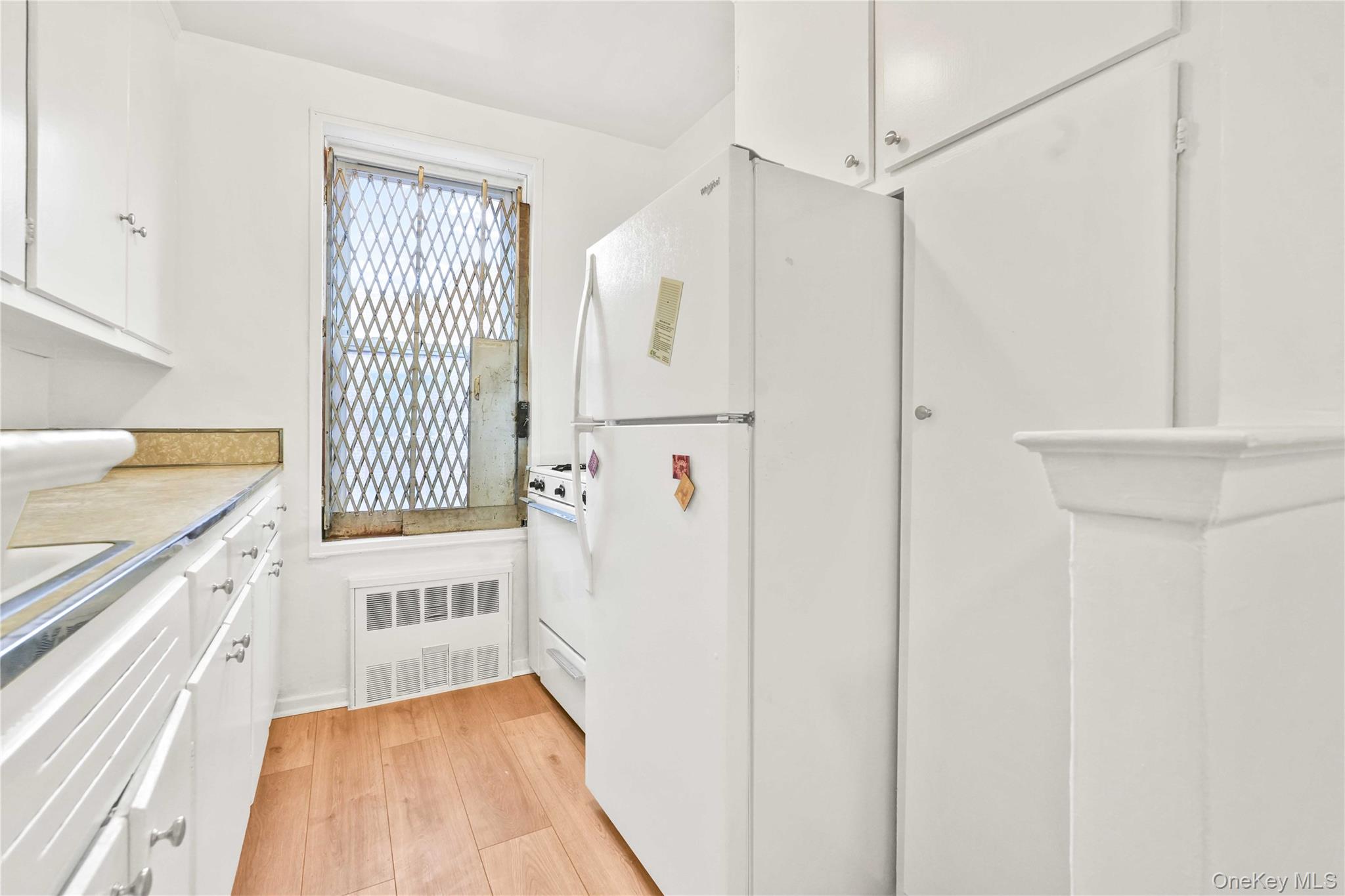 110-15 71st Road, Unit 6J Queens, NY 11375 - Photo 14 of 23 a kitchen with a refrigerator a sink and dishwasher