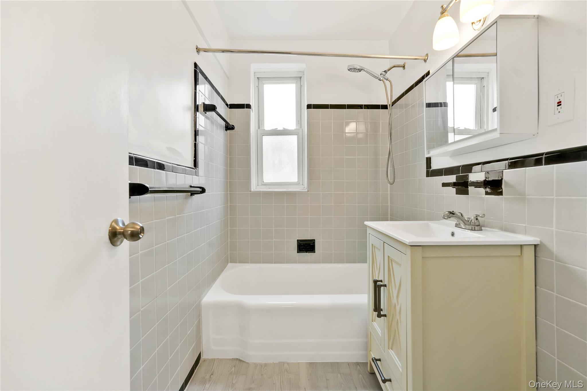 110-15 71st Road, Unit 6J Queens, NY 11375 - Photo 17 of 23 a bathroom with a tub a sink and mirror
