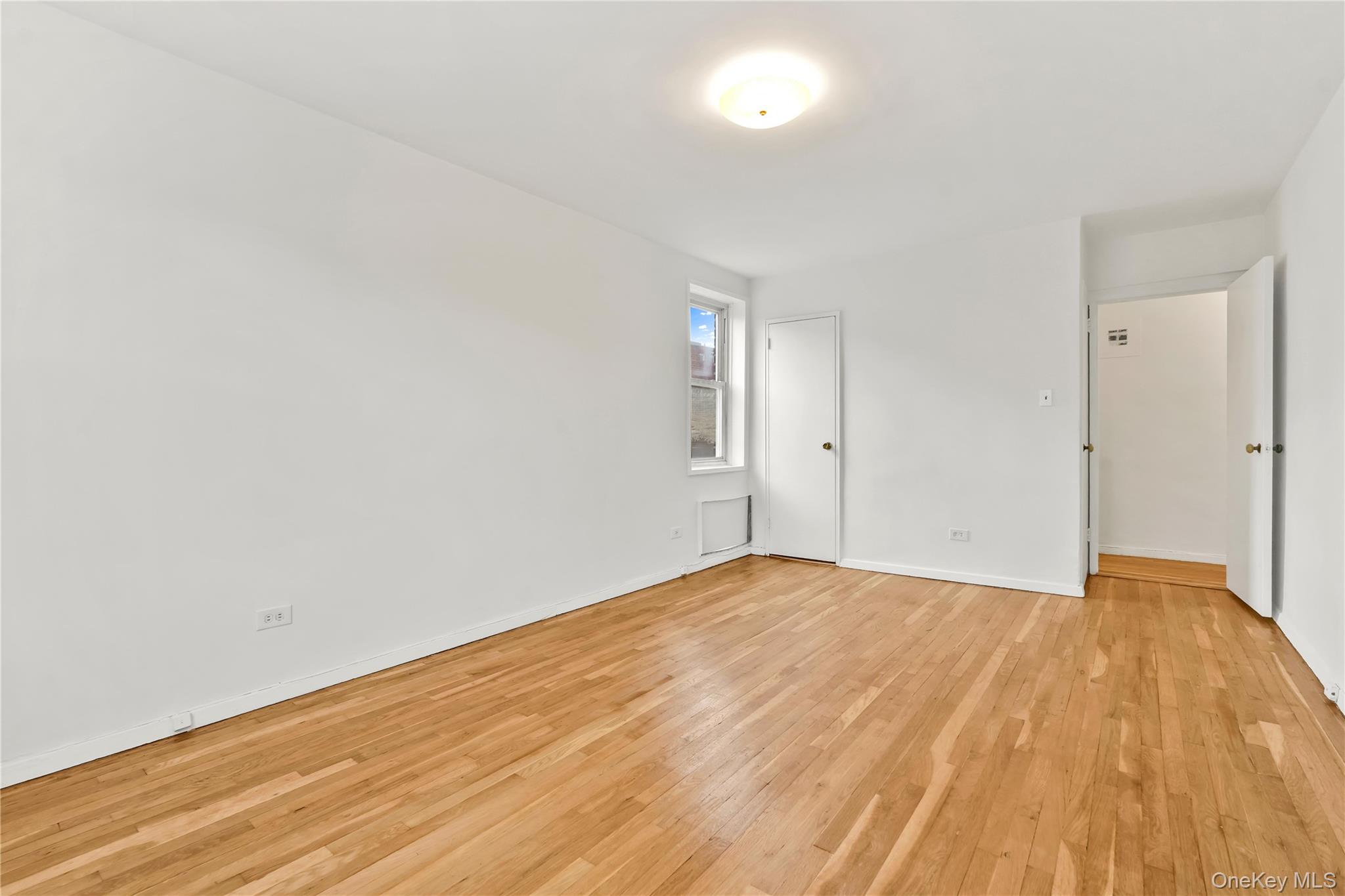 110-15 71st Road, Unit 6J Queens, NY 11375 - Photo 18 of 23 a view of an empty room and wooden floor