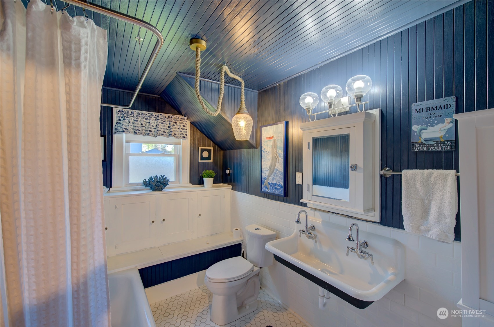 4202 L Place Seaview, WA 98644 - Photo 17 of 39 a bathroom with a sink a toilet and mirror