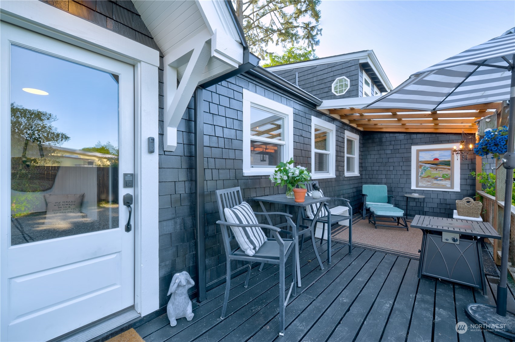 4202 L Place Seaview, WA 98644 - Photo 32 of 39 a patio with wooden table and chairs