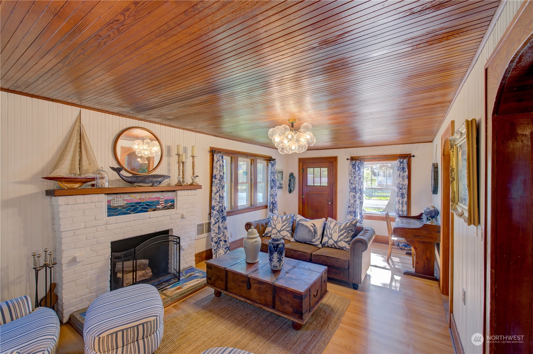 4202 L Place Seaview, WA 98644 - Photo 5 of 39 a living room with furniture a fireplace and a large window