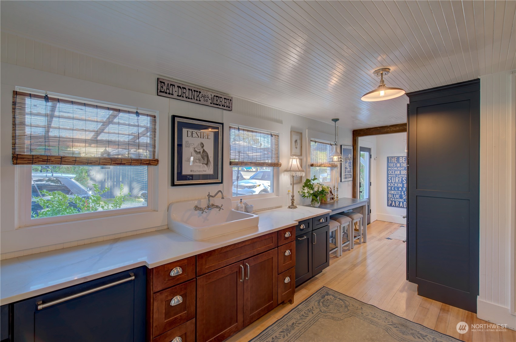 4202 L Place Seaview, WA 98644 - Photo 8 of 39 a hall with stainless steel appliances granite countertop a sink and a large mirror next to a window