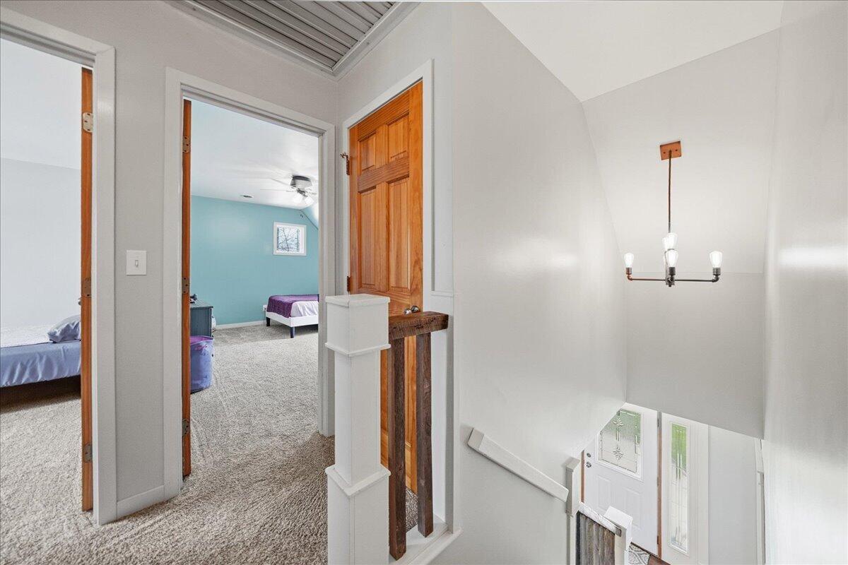 9642 West 1100th Street North Demotte, IN 46310 - Photo 17 of 37 a view of a hallway with a room that has a bed and a mirror