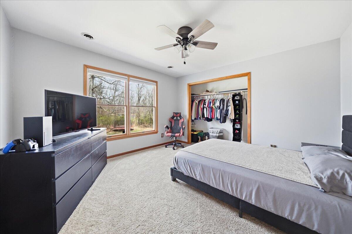 9642 West 1100th Street North Demotte, IN 46310 - Photo 19 of 37 a living room with a bed furniture flat screen tv and a large window