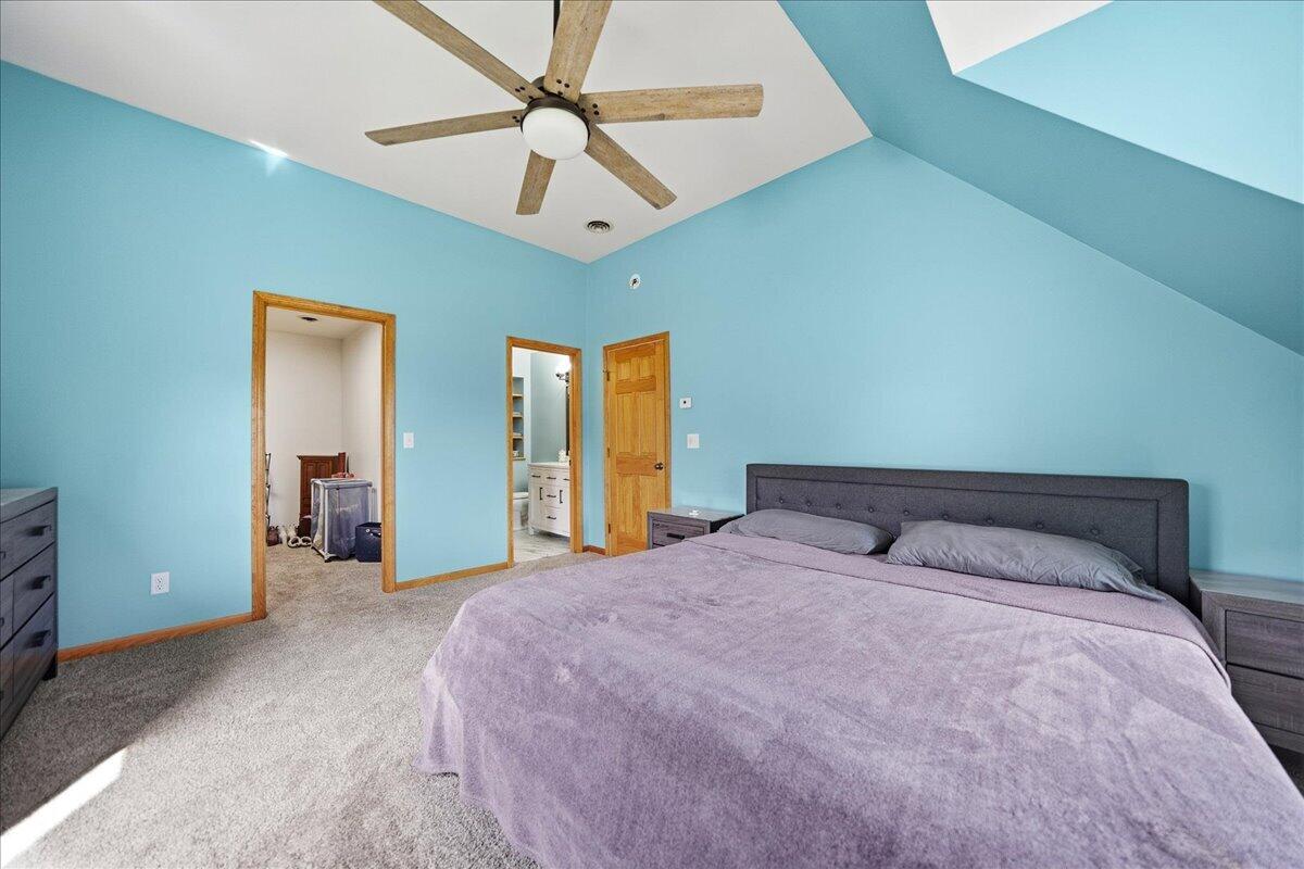 9642 West 1100th Street North Demotte, IN 46310 - Photo 24 of 37 a bedroom with a large bed and a chandelier