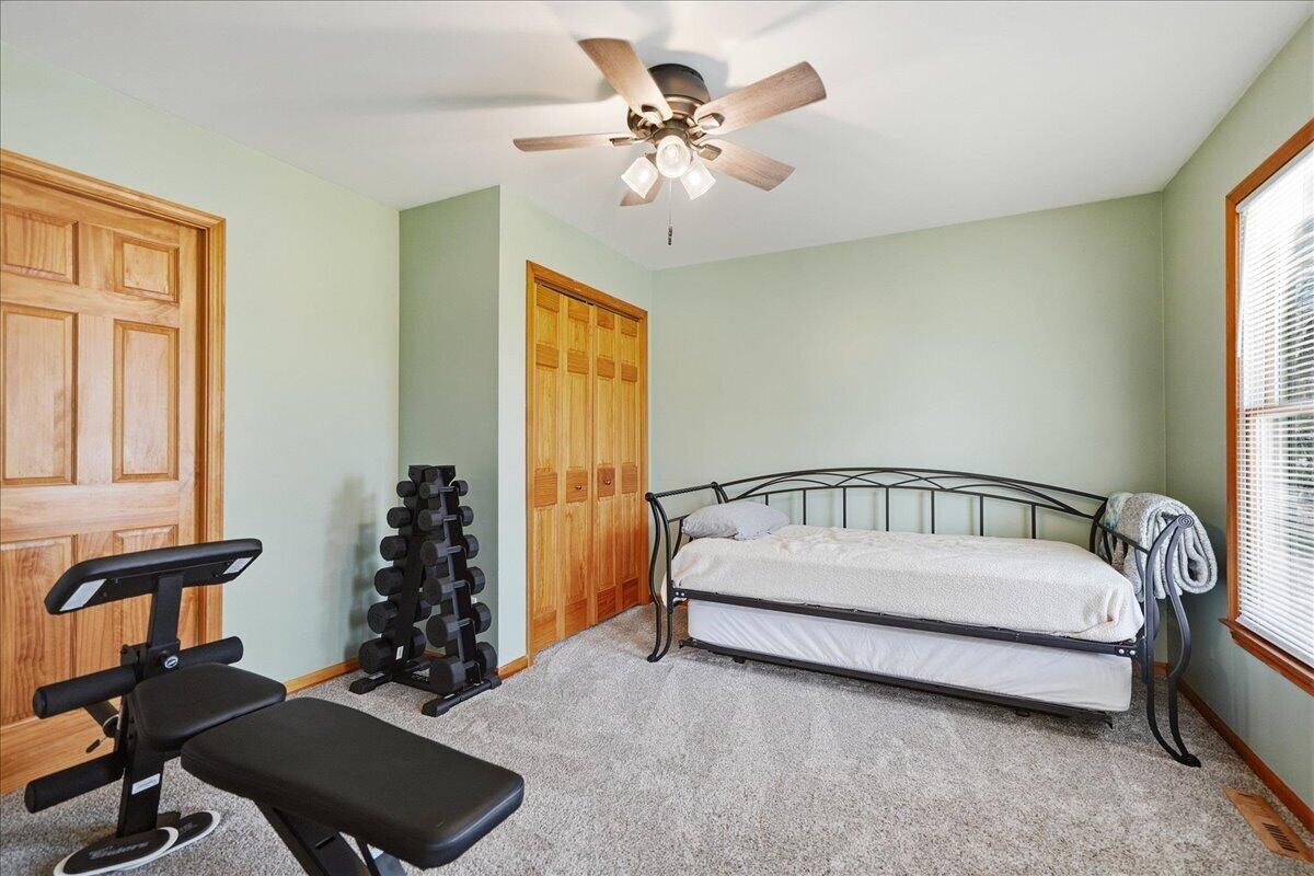9642 West 1100th Street North Demotte, IN 46310 - Photo 25 of 37 a spacious bedroom with a bed and a chandelier