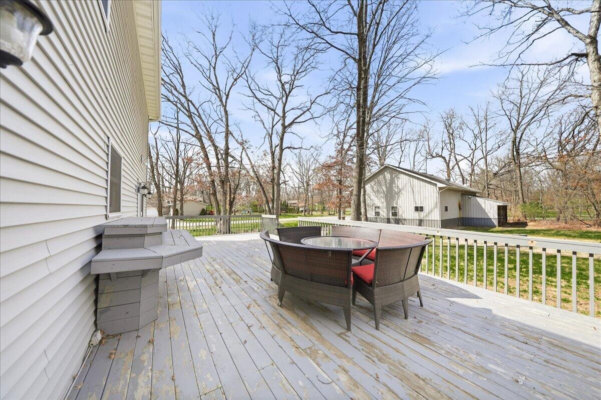 9642 West 1100th Street North Demotte, IN 46310 - Photo 26 of 37 a view of a patio with table and chairs and wooden floor