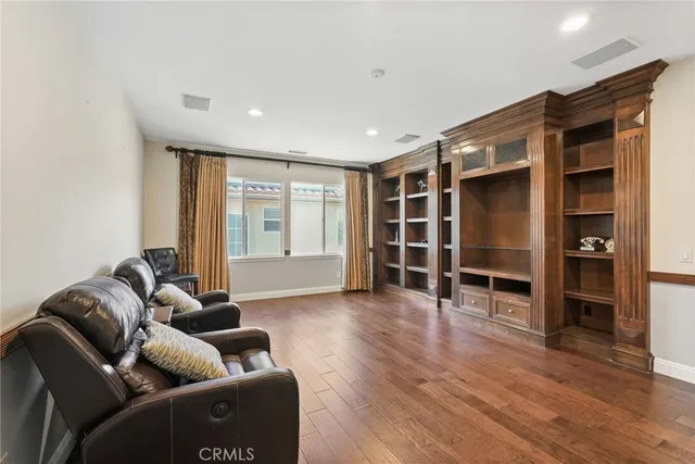 a view of a patio with table and chairs potted plants with floor to ceiling window and potted plants