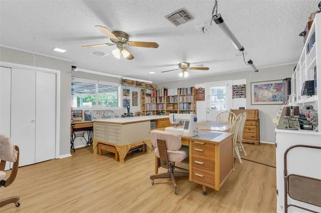 a bedroom with a bed and a potted plant