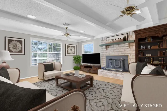 a living room with furniture fireplace and a flat screen tv