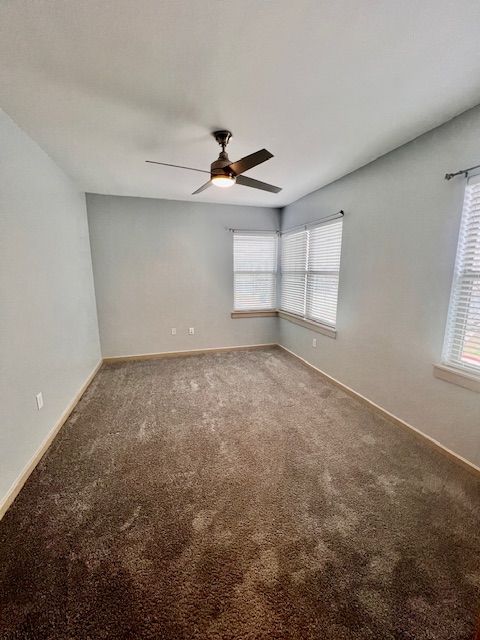 1201 Grove Boulevard, Unit 1901 Austin, TX 78741 - Photo 13 of 19 an empty room with a ceiling fan and a window