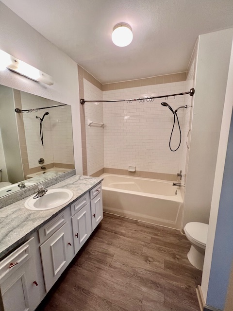 1201 Grove Boulevard, Unit 1901 Austin, TX 78741 - Photo 15 of 19 a bathroom with a double vanity sink toilet mirror and shower