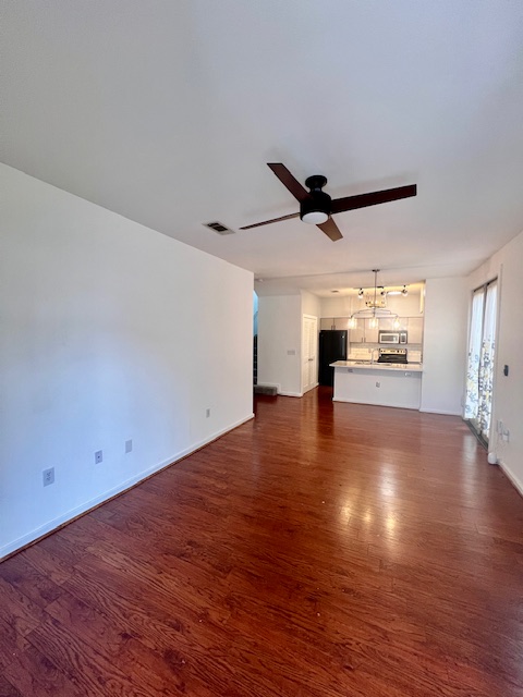 1201 Grove Boulevard, Unit 1901 Austin, TX 78741 - Photo 3 of 19 a view of empty room with wooden floor and ceiling fan
