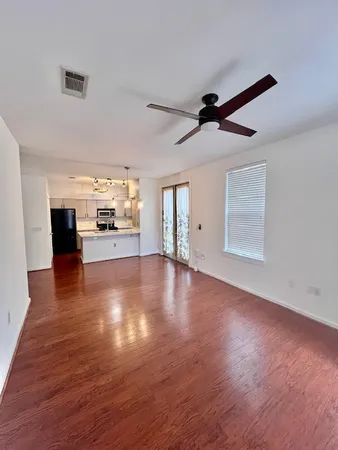 a view of empty room with wooden floor and fireplace