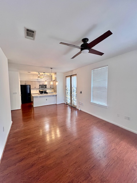1201 Grove Boulevard, Unit 1901 Austin, TX 78741 - Photo 4 of 19 a view of empty room with wooden floor and fireplace
