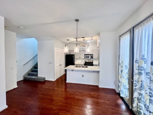 a kitchen with stainless steel appliances a stove top oven and cabinets