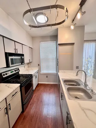 a kitchen with a sink stove and refrigerator