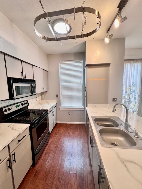 1201 Grove Boulevard, Unit 1901 Austin, TX 78741 - Photo 9 of 19 a kitchen with a sink stove and refrigerator