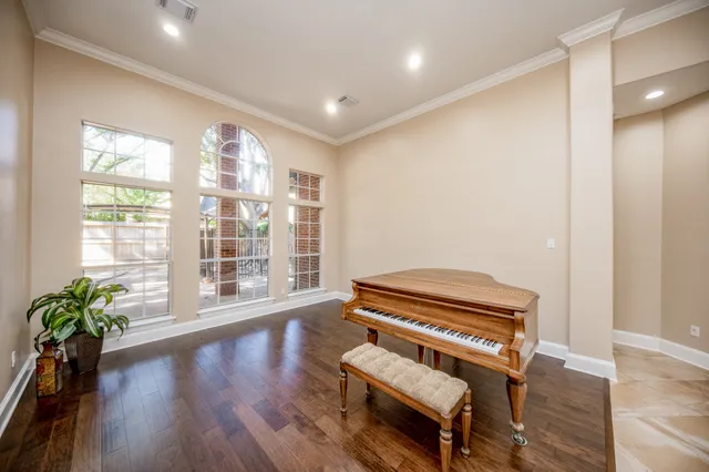 a living room with furniture and a piano
