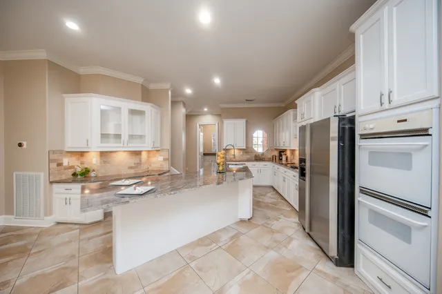 a kitchen with refrigerator and cabinets