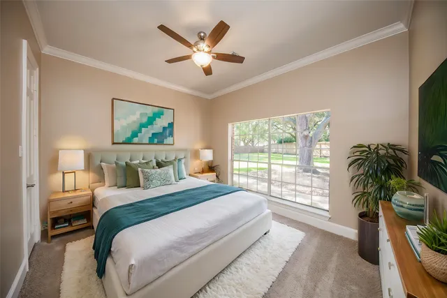 a bedroom with a large bed and a large window
