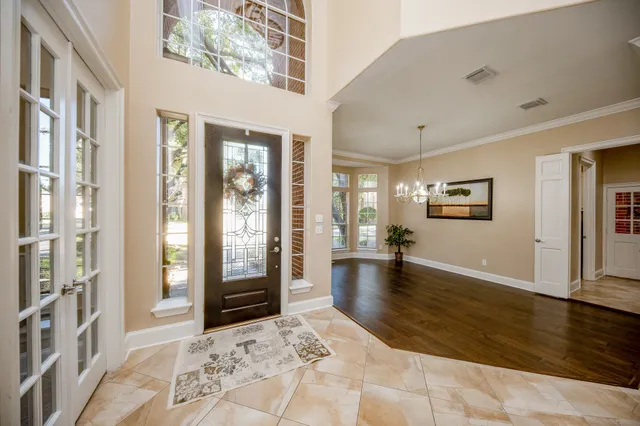 a view of a big room with windows and wooden floor