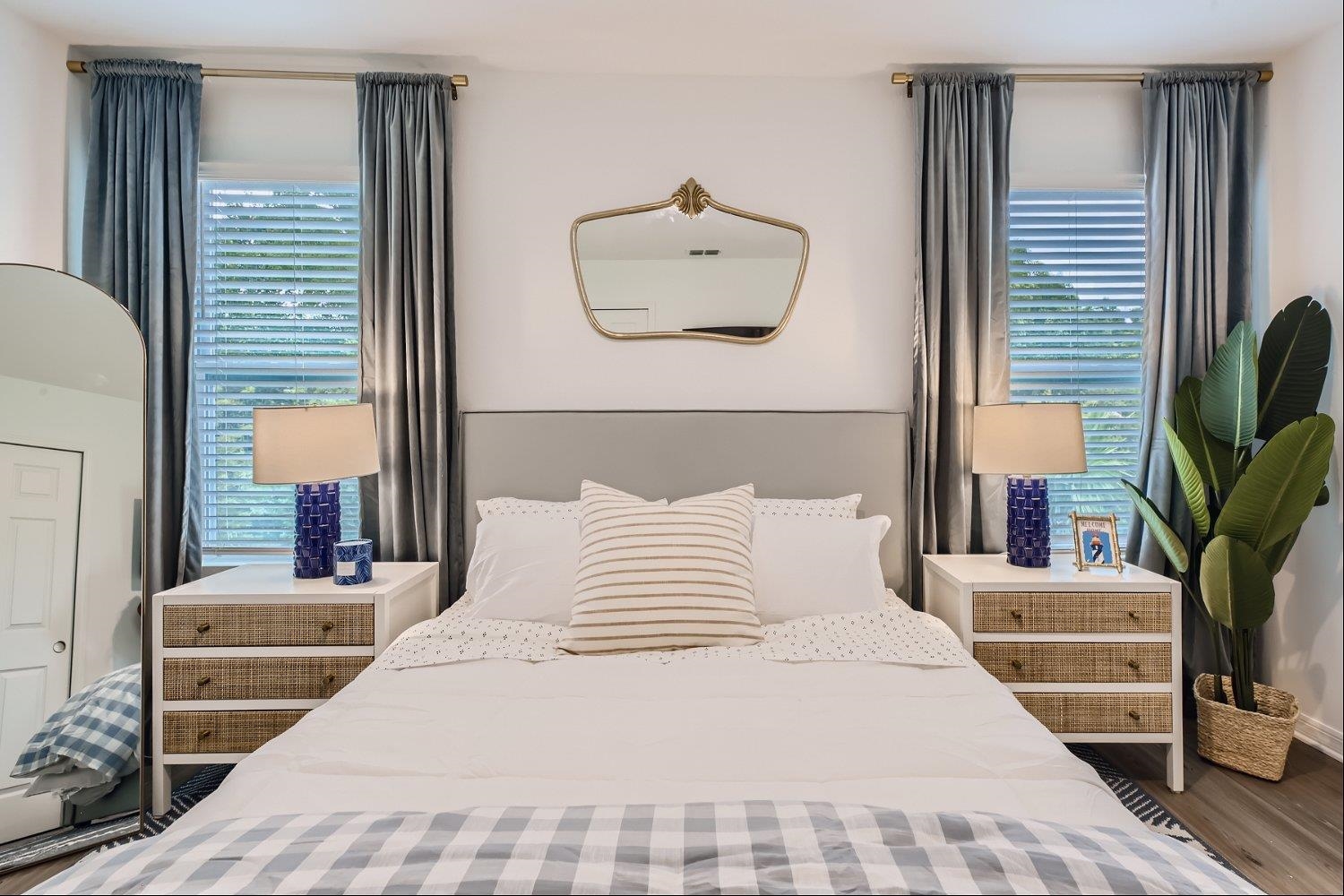 83 Pamplona Drive St. Augustine, FL 32086 - Photo 27 of 66 a bedroom with a large bed and a potted plant