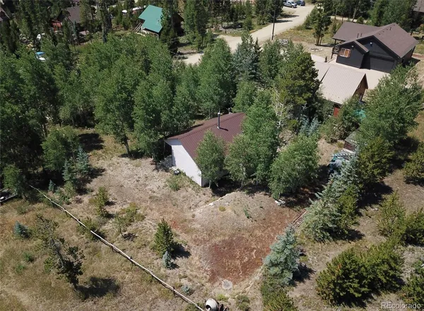 an aerial view of a house with a yard