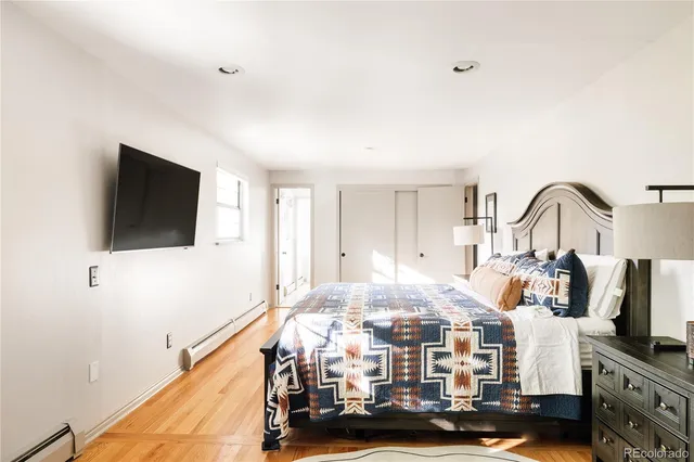 a bedroom with furniture and a flat screen tv