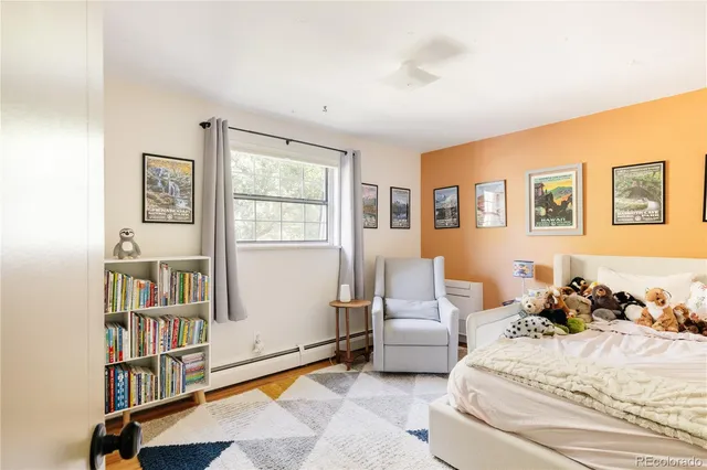 a spacious bedroom with a bed and a book shelf