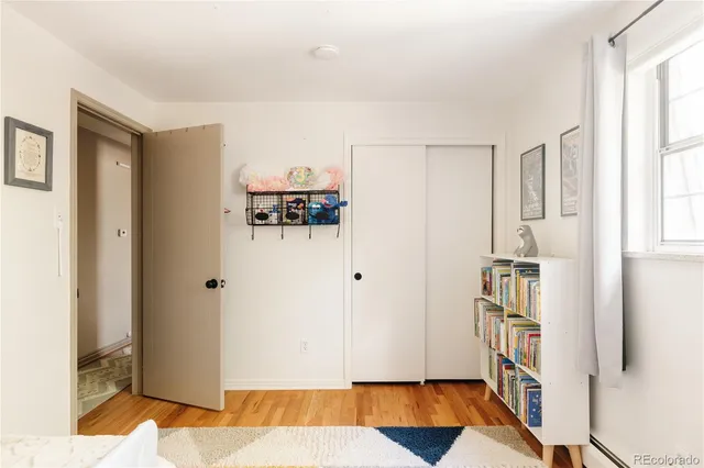 a view of walk in closet with window and wooden floor