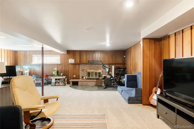 a living room with furniture a flat screen tv and large window