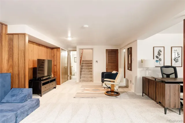 a view of a livingroom with furniture and a flat screen tv