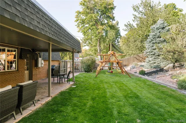 a view of a house with backyard and sitting area