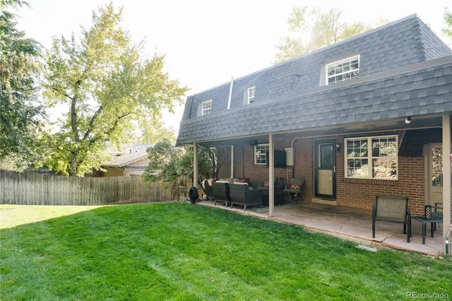 a view of a house with a yard and sitting area