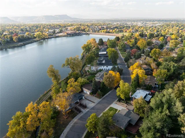 an aerial view of a houses with a lake