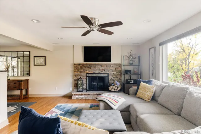 a living room with furniture a fireplace and a flat screen tv