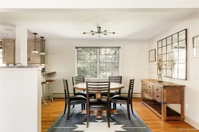 a view of a dining room with furniture and chandelier