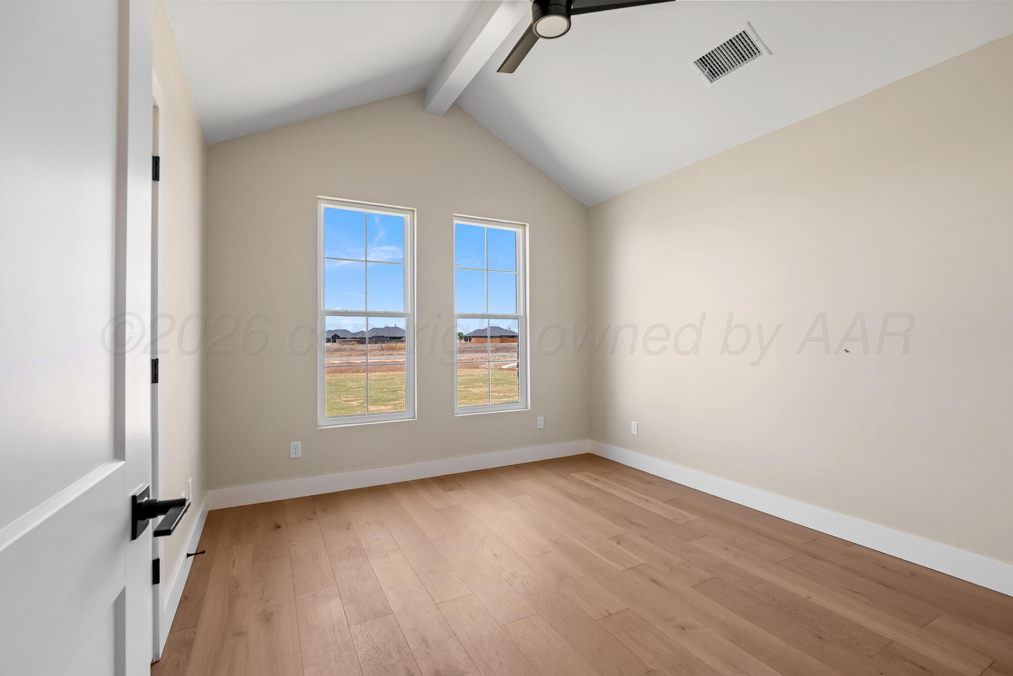 4201 Juniper Springs Road Amarillo, TX 79119 - Photo 13 of 27 an empty room with wooden floor and windows