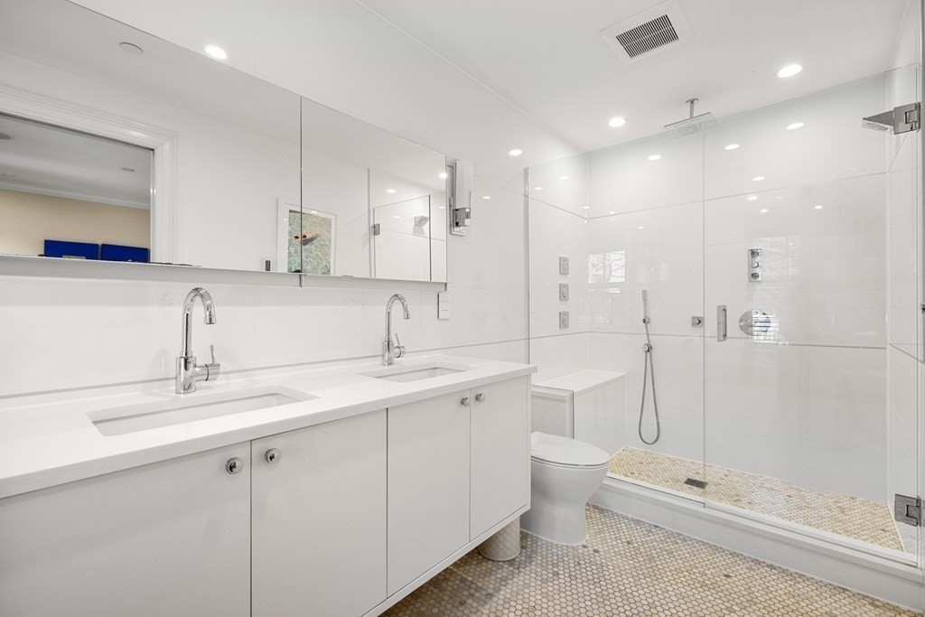 211 West Canton Street, Unit 1 Boston, MA 02116 - Photo 11 of 33 a bathroom with a double vanity sink toilet and shower
