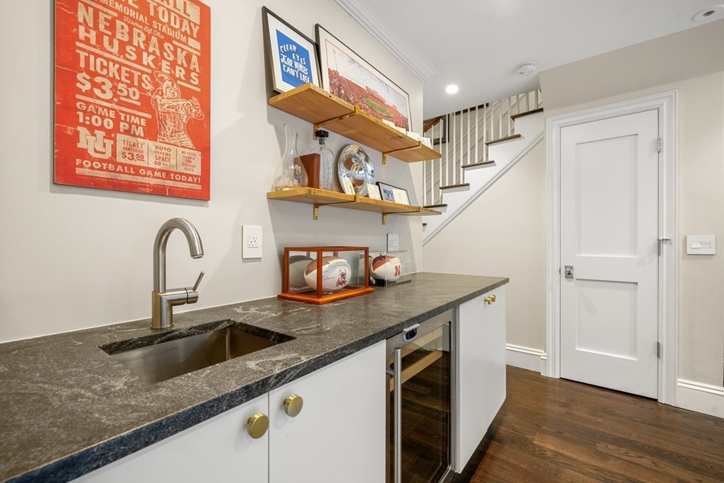 211 West Canton Street, Unit 1 Boston, MA 02116 - Photo 26 of 33 a kitchen with stainless steel appliances granite countertop a sink and a wooden floors
