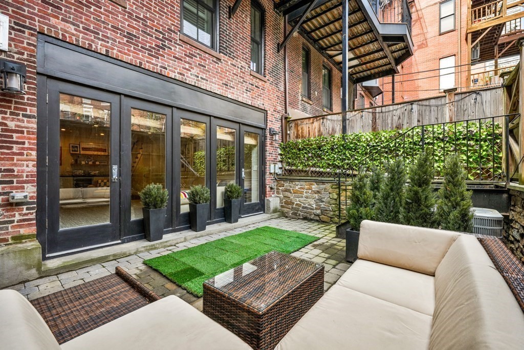 211 West Canton Street, Unit 1 Boston, MA 02116 - Photo 28 of 33 a view of a backyard with couches chair and wooden floor