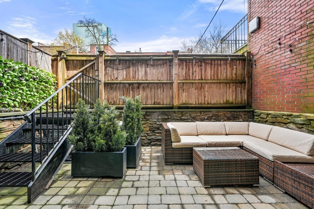 211 West Canton Street, Unit 1 Boston, MA 02116 - Photo 29 of 33 a view of a chairs and tables in the back yard of the house